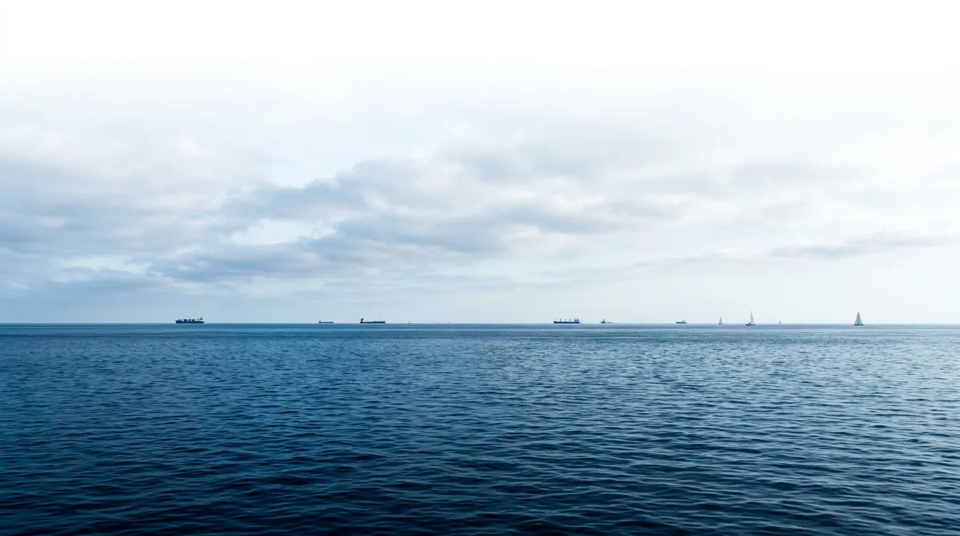 Serene Ocean Horizon with Atmospheric Clouds and Distant Ships